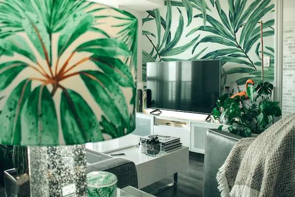 A green and white living room with many leaf prints all around.