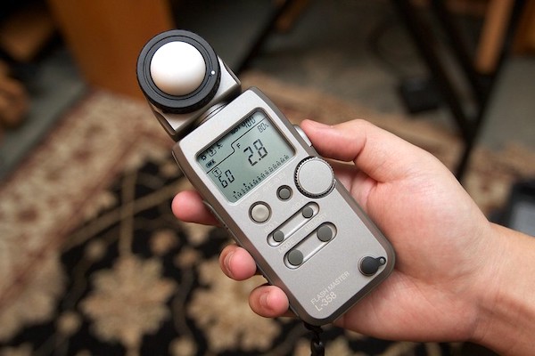 a person holding a light meter