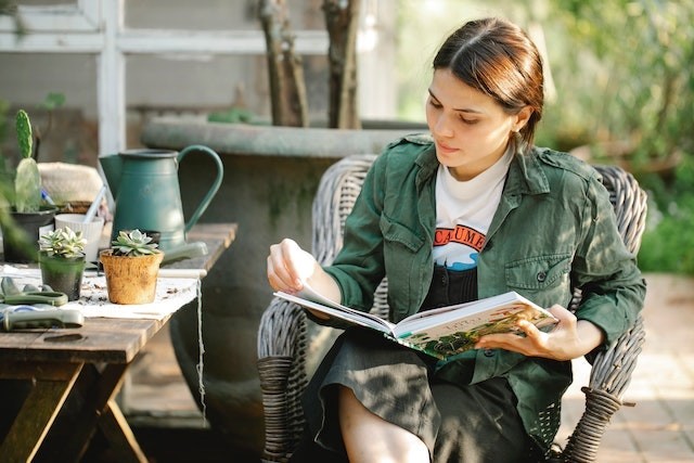 Woman reading a gardening book.